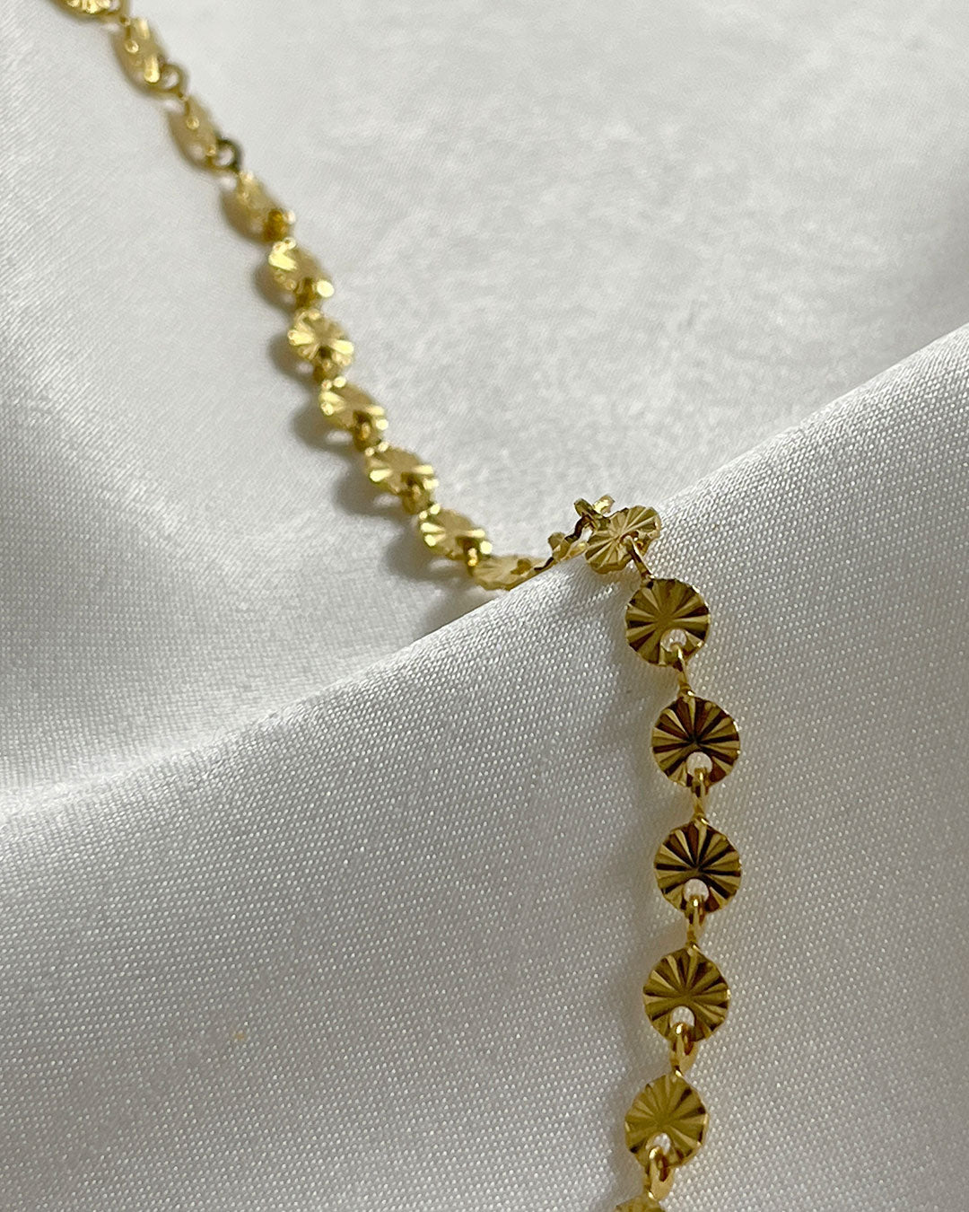 Close-up look of a gold sun chain bracelet
