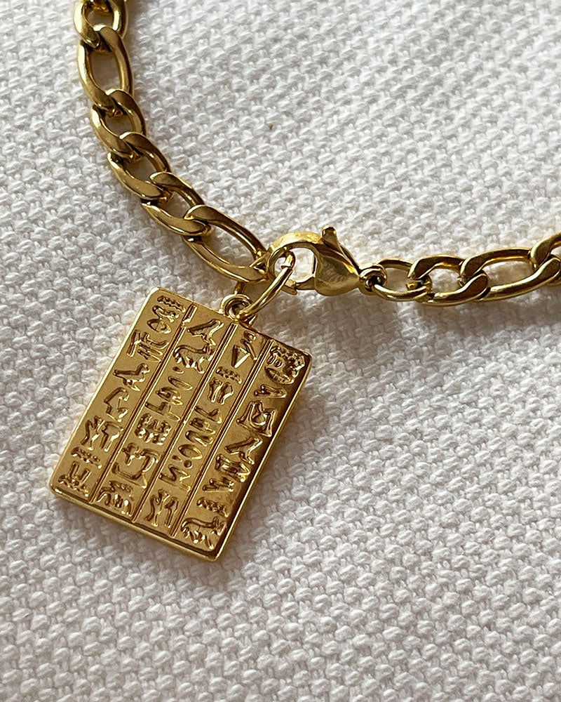 Egyptian style chain bracelet with a tag charm in gold