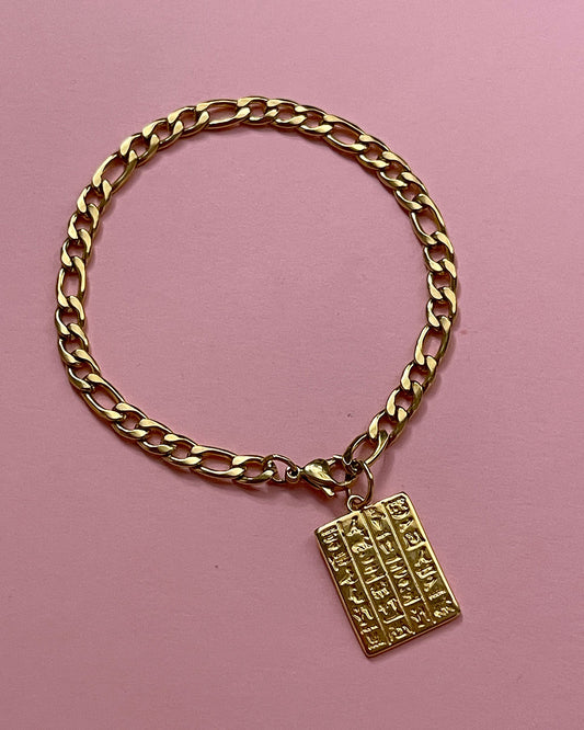 Egyptian style chain bracelet with a tag charm in gold