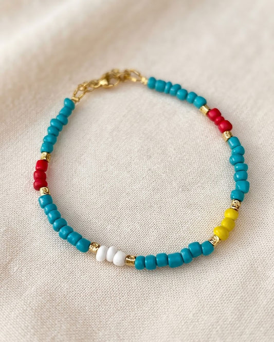A Rainbow Beaded Summer Anklet adorned with gold metal beads