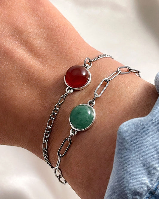 Silver bracelets with carnelian and aventurine stones on a wrist against a neutral background. Bundle set