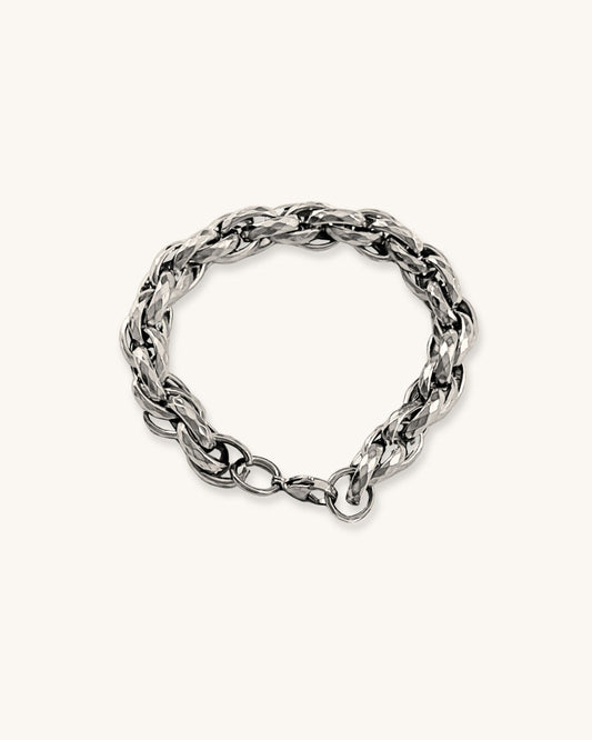 Silver chunky braided chain bracelet on a white background