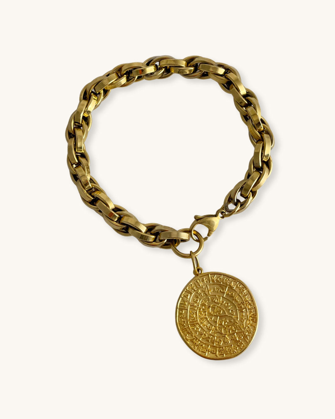 Gold chain bracelet with a round Phaistos disc on a white background