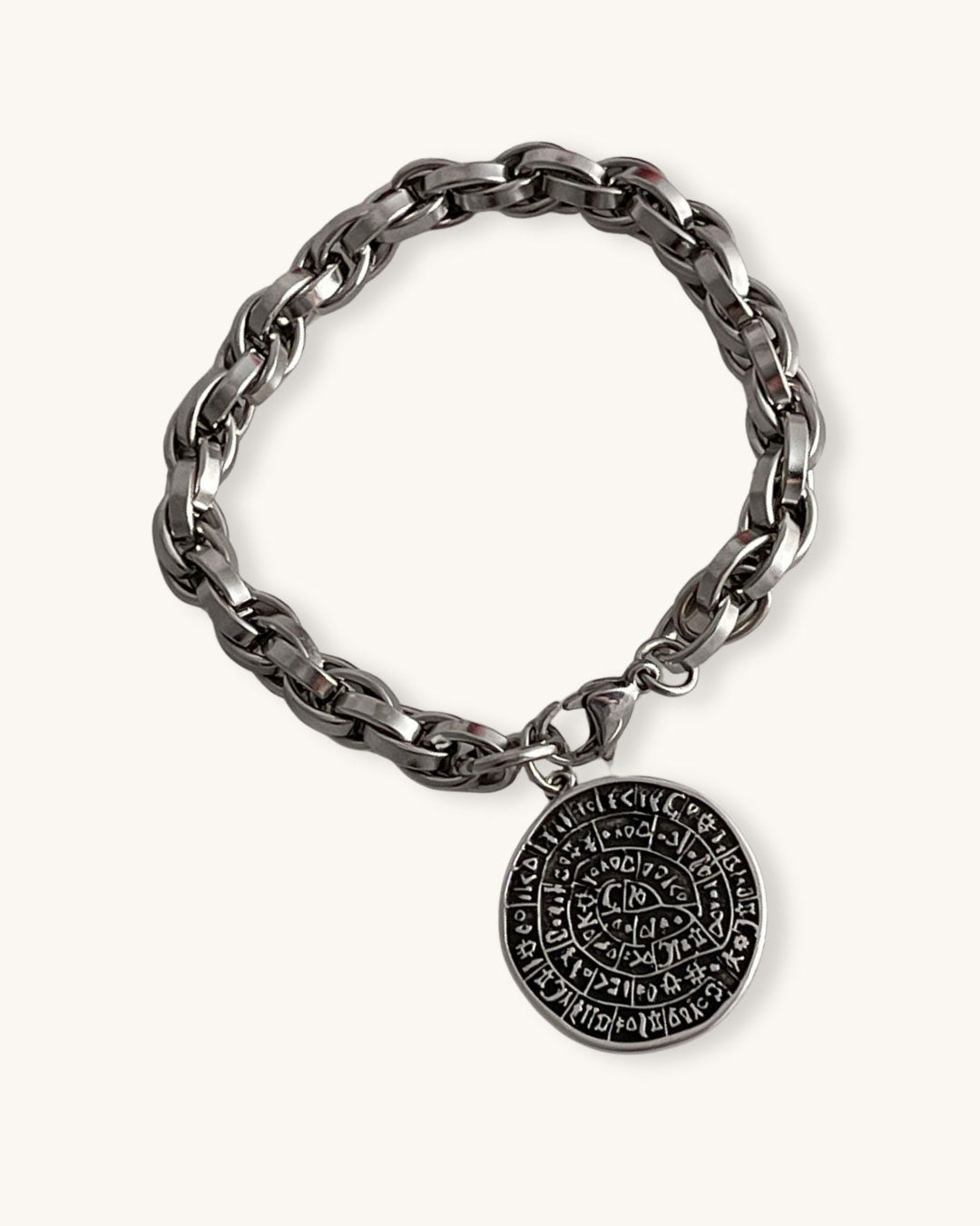 Silver chain bracelet with a round Phaistos disc on a white background