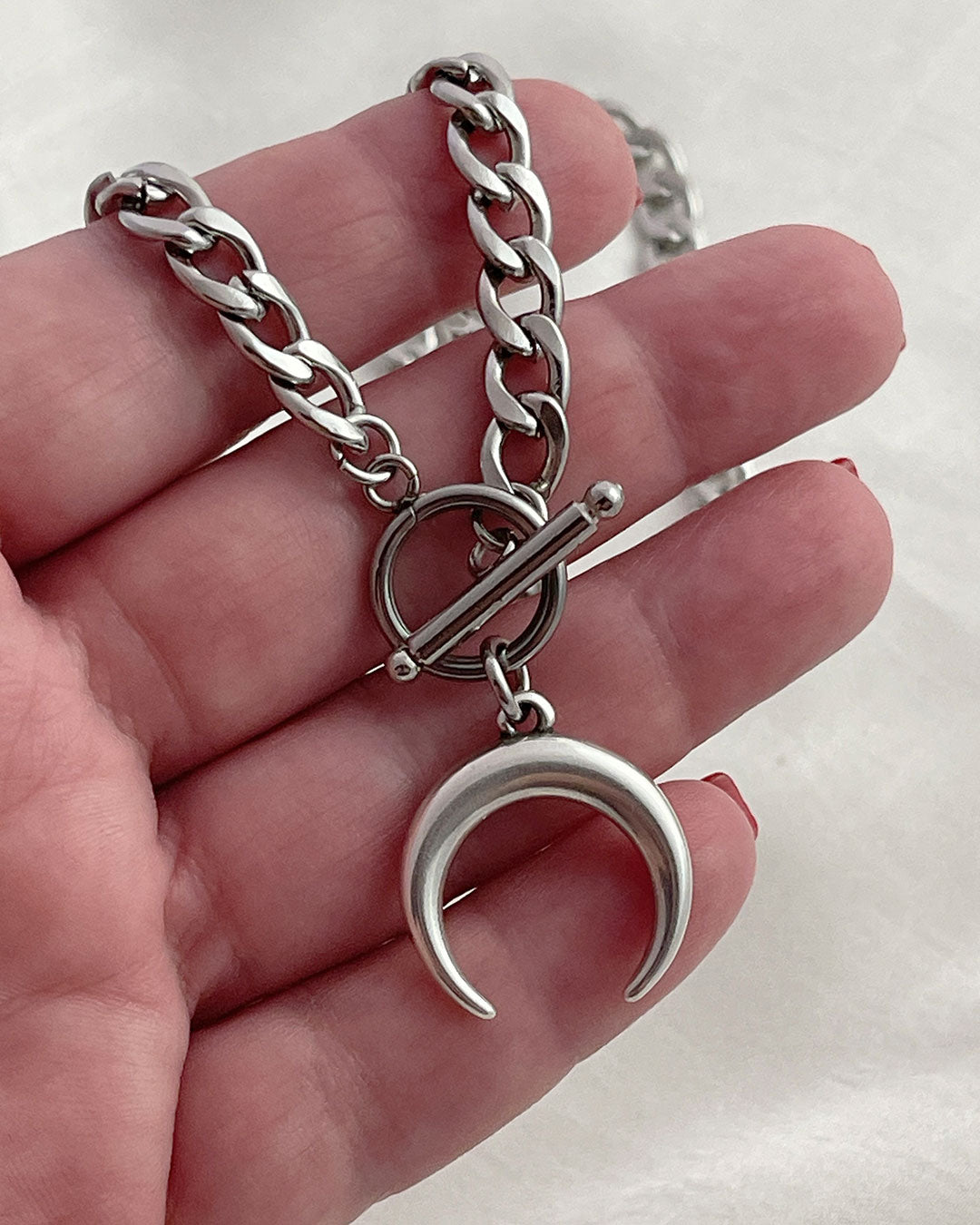 Handcrafted silver crescent moon necklace with a toggle clasp for easy wear