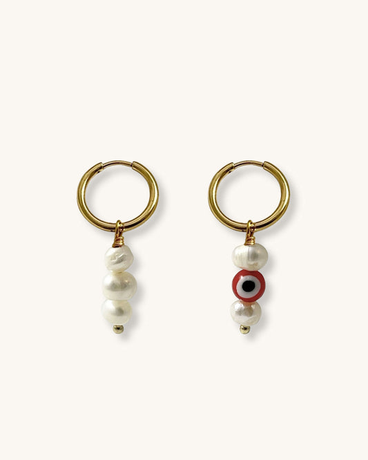 The Evil Eye Pearl Hoop Earrings, a pair of gold hoop earrings featuring freshwater pearls.