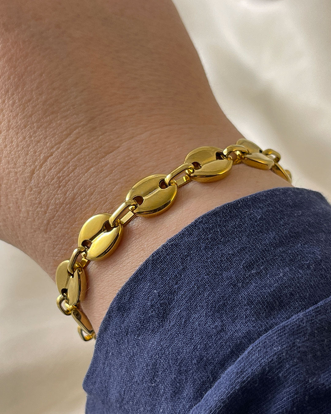 Wrist with puffed mariner chain bracelet in gold finish