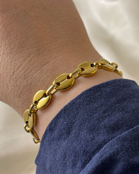 Wrist with puffed mariner chain bracelet in gold finish