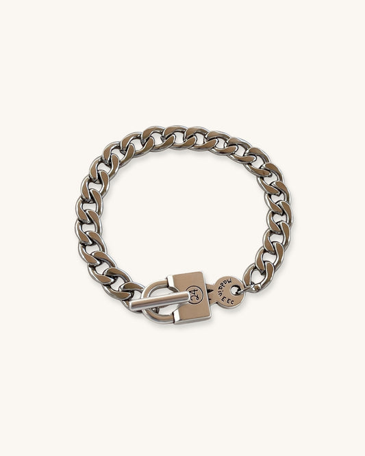 Silver chain bracelet with a padlock clasp on a white background