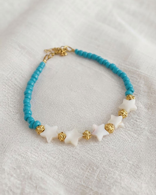 A Blue Boho Stars Beaded Anklet adorned with blue beads abd shell stars