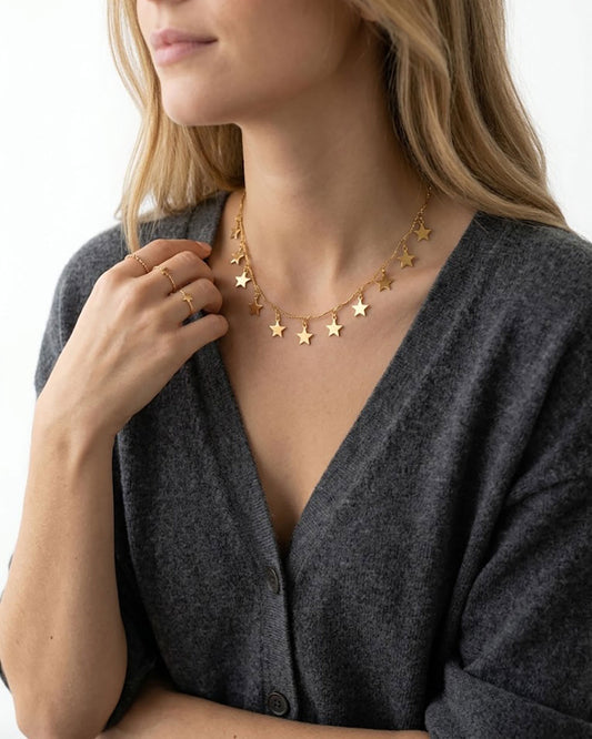 Woman wearing a gold necklace with star charms