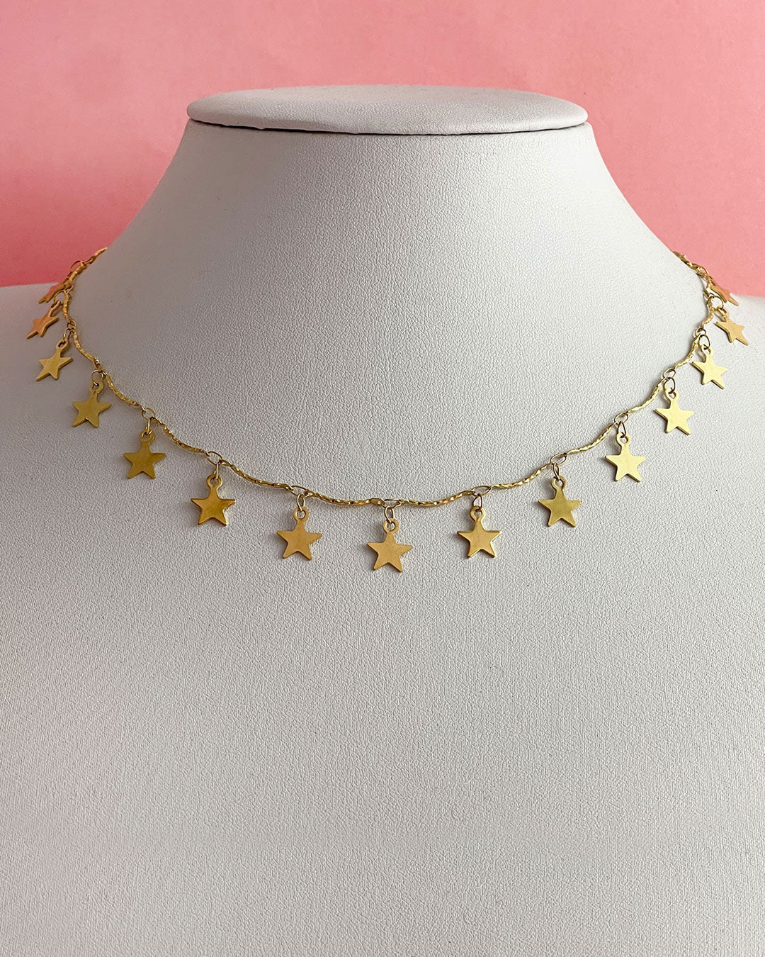 A gold choker necklace full of star charms