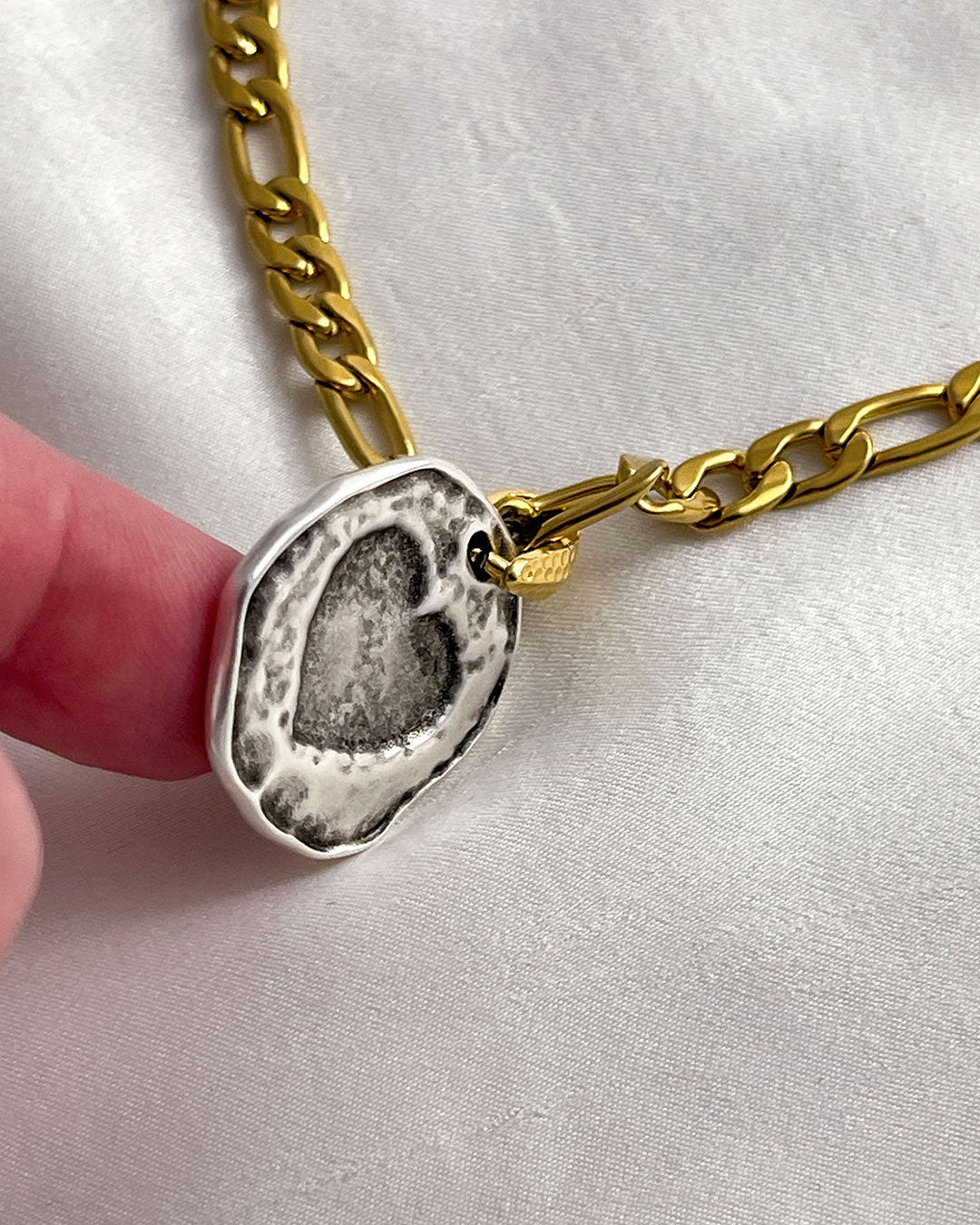 Close-up details from the round heart pendant