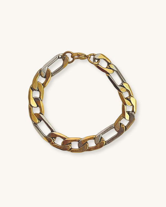 Two tone gold and silver chain bracelet on a white background