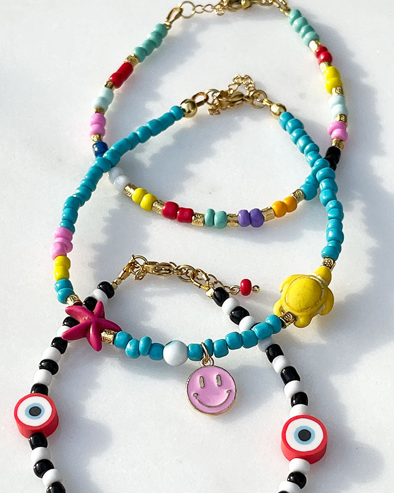 A colorful glass beaded anklet adorned with gold metal beads