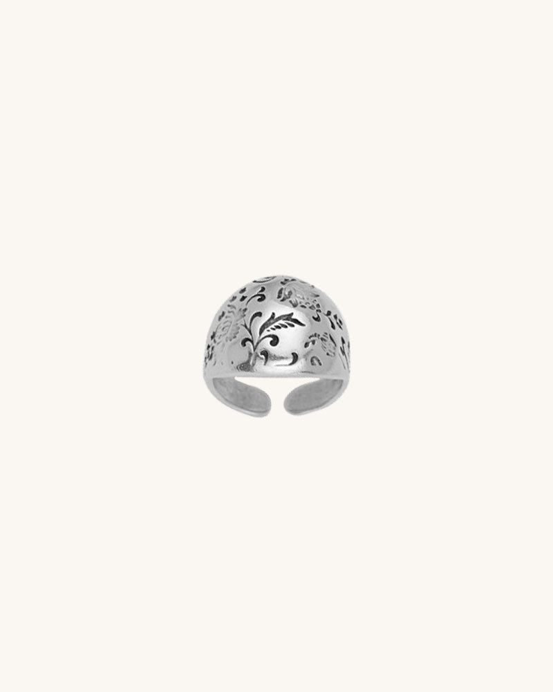 A silver floral dome ring.