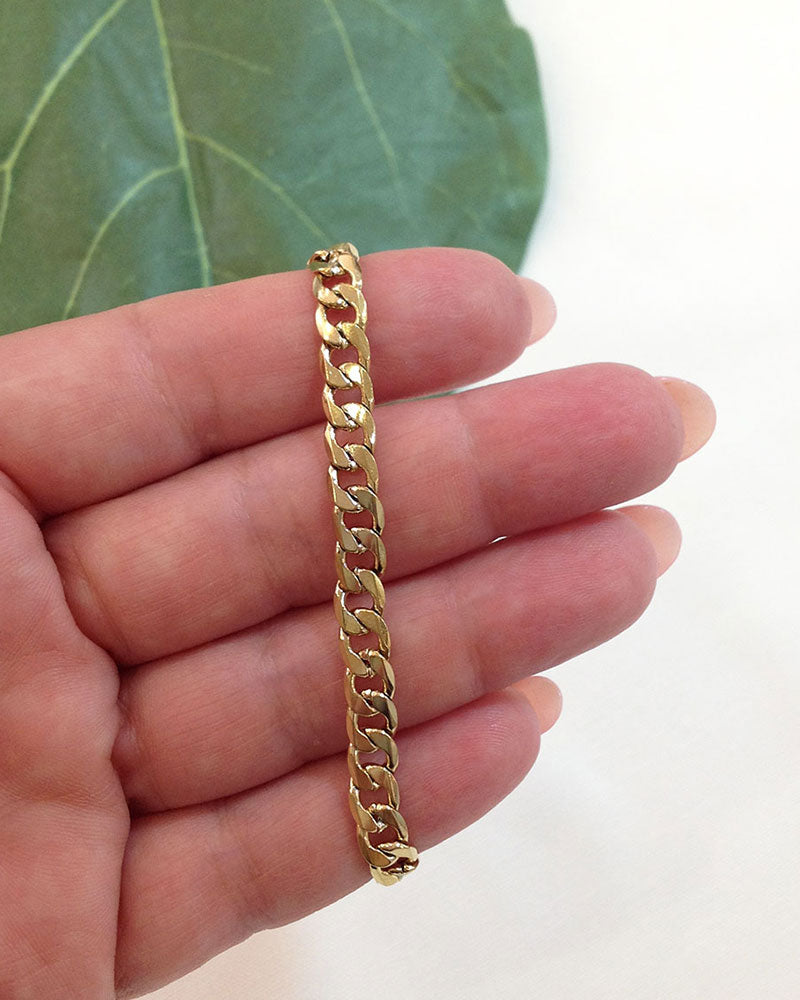 Close-up look of a gold curb chain bracelet