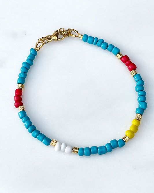 A Rainbow Beaded Summer Anklet adorned with gold metal beads