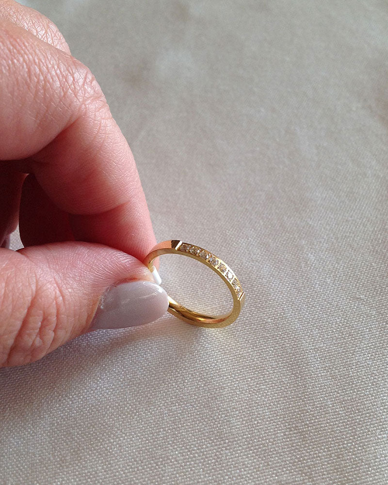 A waterproof gold band ring in white crystal