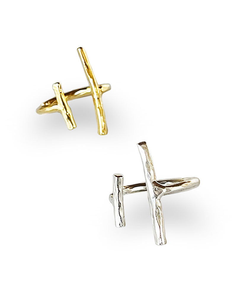 A hammered finish on a simple open bar design ring in silver and gold