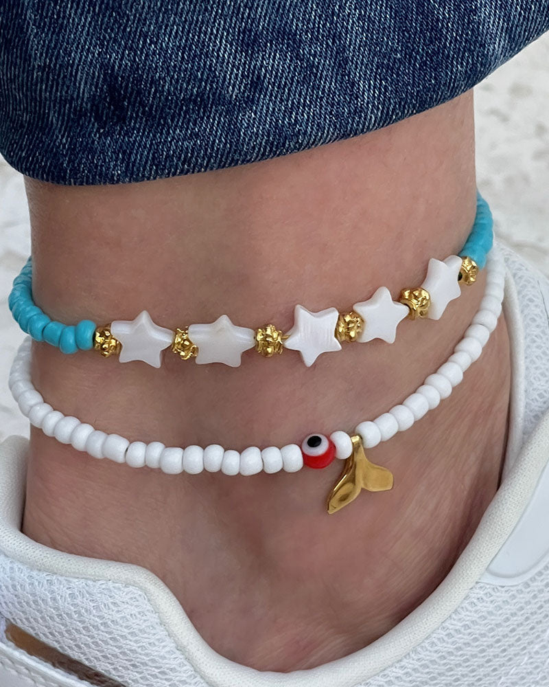 A Blue Boho Stars Beaded Anklet adorned with blue beads abd shell stars