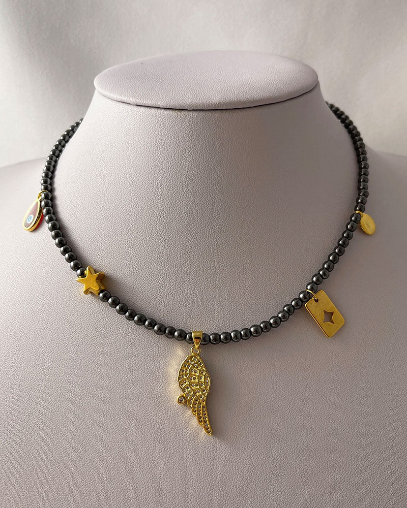 hematite beaded necklace with angle wing , star and eye charms