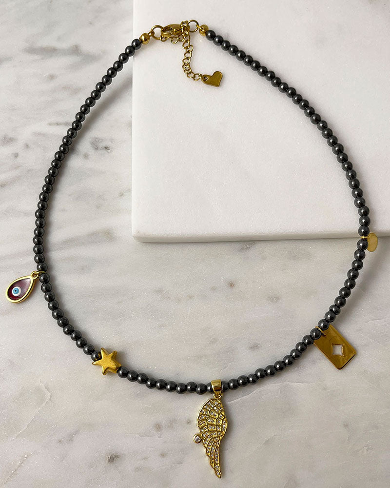 hematite beaded necklace with angle wing , star and eye charms