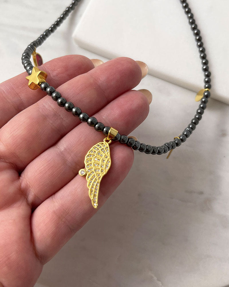 hematite beaded necklace with angle wing , star and eye charms