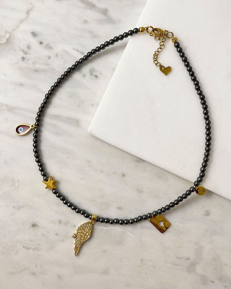 hematite beaded necklace with angle wing , star and eye charms