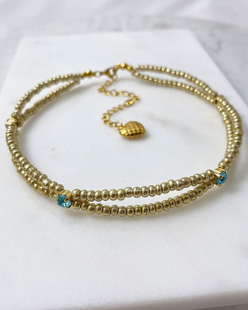 gold bead choker necklace with light turquoise crystals