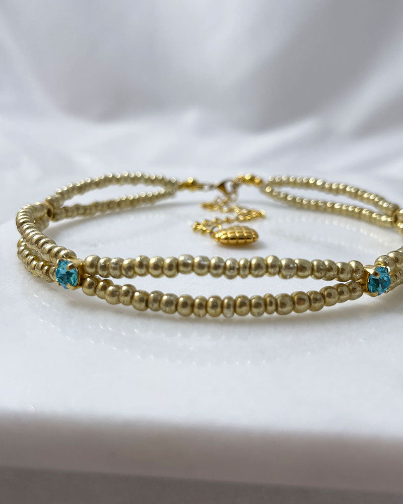 gold bead choker necklace with light turquoise crystals