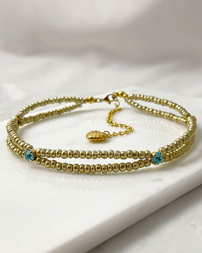 gold bead choker necklace with light turquoise crystals