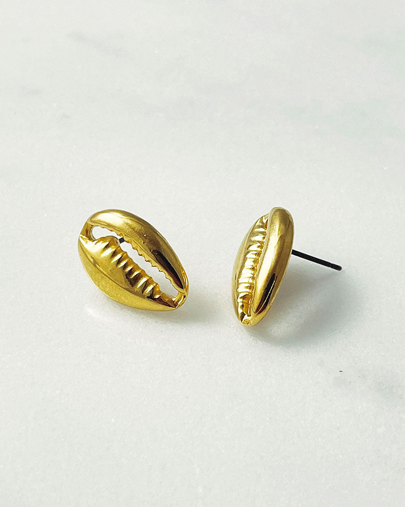 The Cowrie Stud Earrings, a pair of gold earrings
