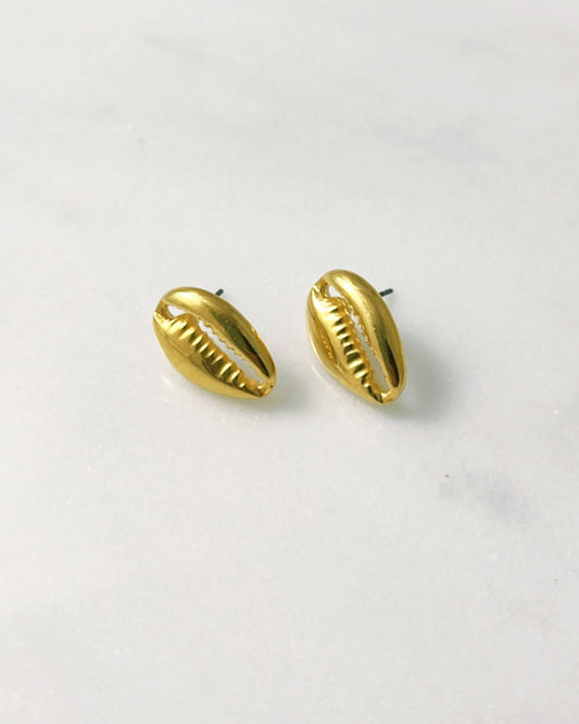 The Cowrie Stud Earrings, a pair of gold earrings