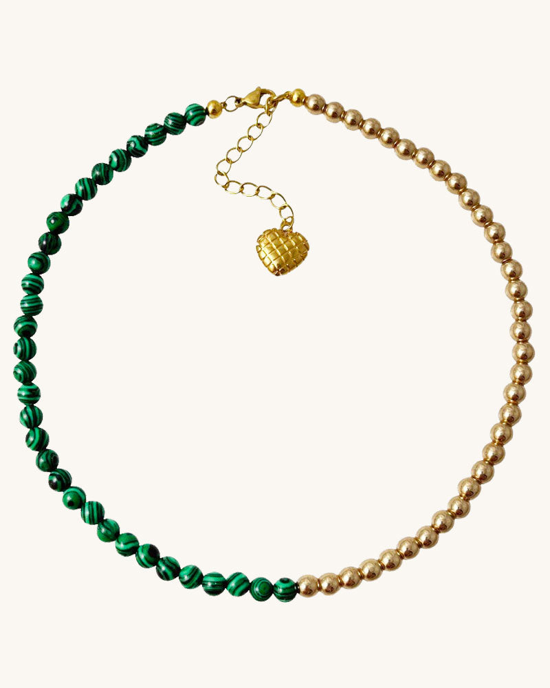 A handmade minimalist necklace with green malachite and gold hematite beads