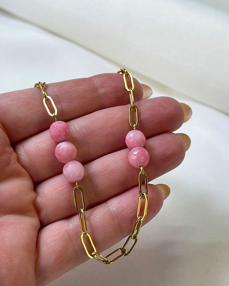 A pink agate statement necklace with a gold paperclip chain