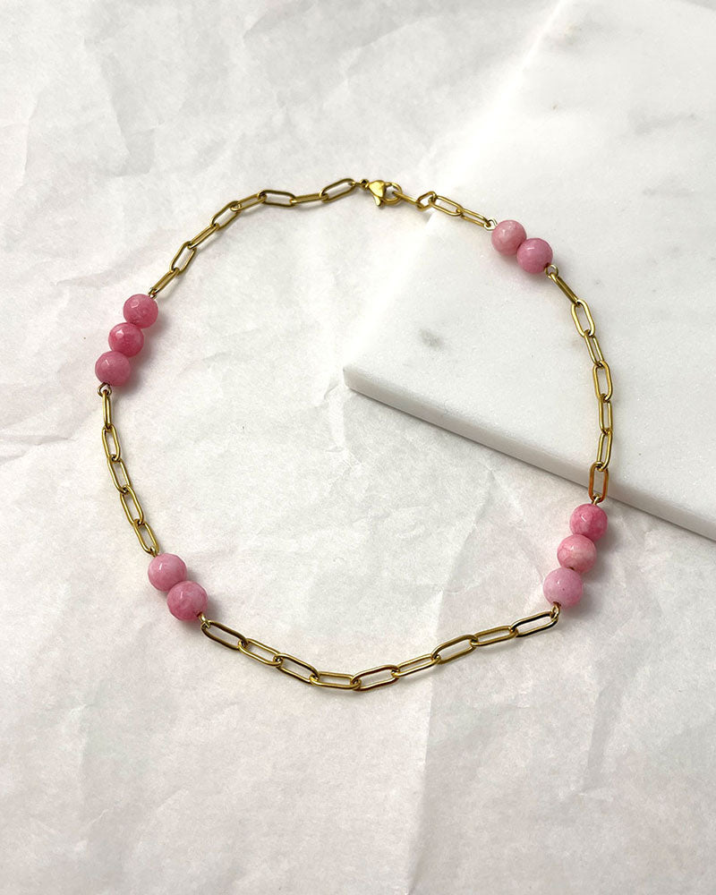 A pink agate statement necklace with a gold paperclip chain