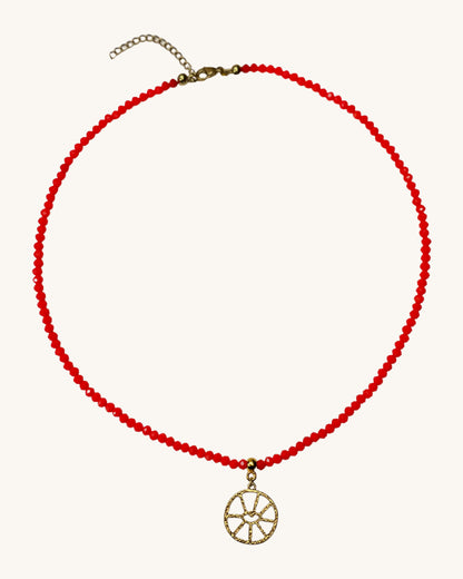 A red beaded necklace with an evil eye round oendant.