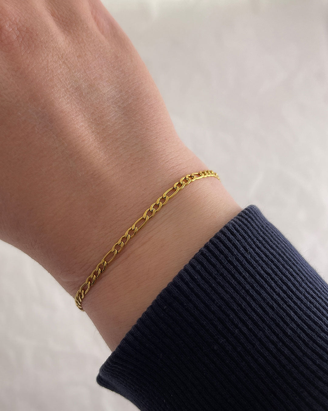 A delicate figaro chain bracelet in gold