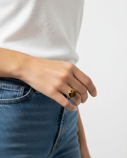 Model wearing a gold waterproof adjustable band ring with a tiger eye stone