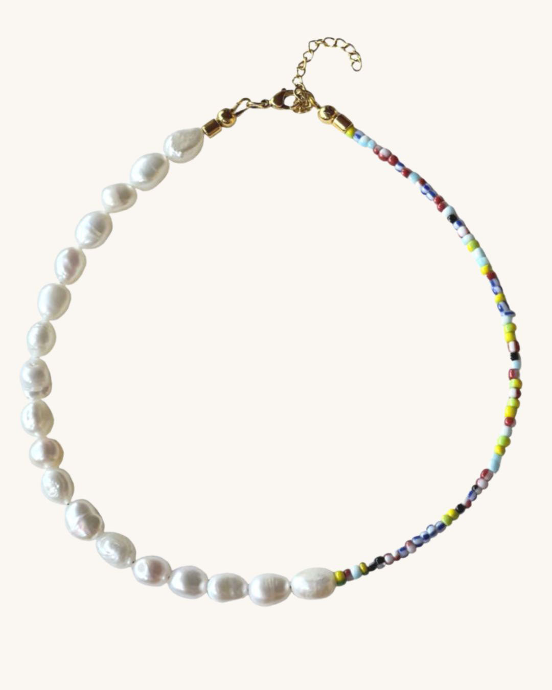 The Venetia Necklace is a half colorful beads and half pearls beaded necklace perfect for layering
