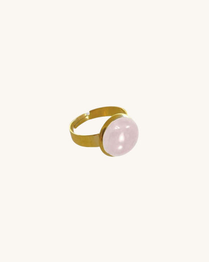 A gold waterproof adjustable band ring with a rose quartz stone