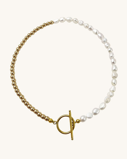 Handmade necklace with hlaf pearls and half gold hematite beads. Toggle closure