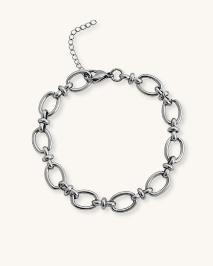 Silver oval link chain bracelet on a white background