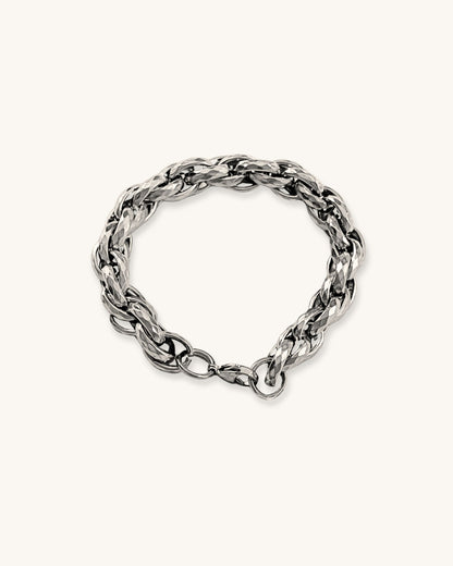 Silver chunky braided chain bracelet on a white background