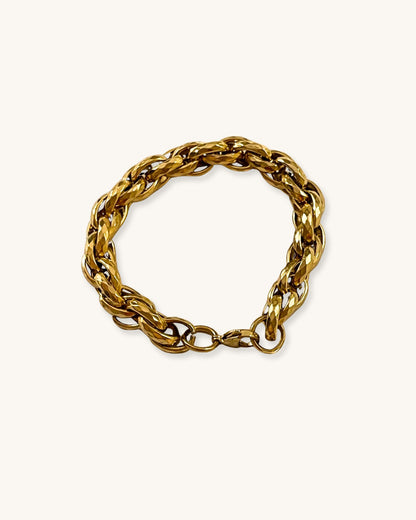 Gold chunky braided chain bracelet on a white background