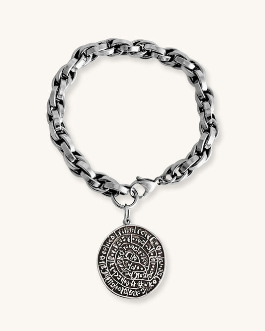 Silver chunky chain bracelet with a round Phaistos disc charm on a white background