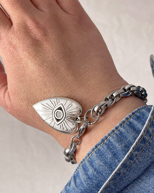 Our gorgeous silver chunky chain evil eye heart charm bracelet enhances a woman's wrist with its exquisite design and timeless allure.
