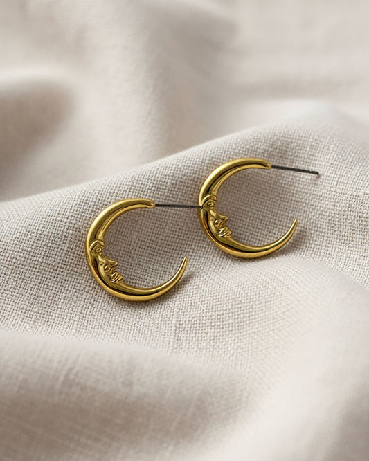 A pair of half-moon-shaped gold earrings