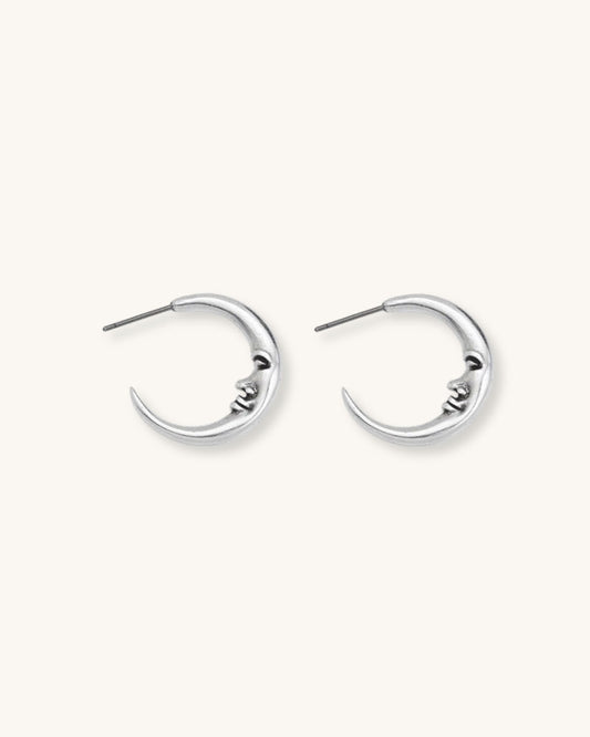 The Crescent Moon Earrings, a pair of half-moon-shaped silver earrings